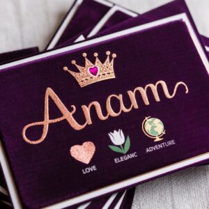 Luxurious purple and rose gold card featuring "Anam," adorned with a rose gold crown and colorful icons.