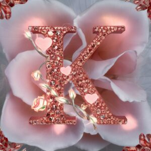 Elegant 'K' with delicate hearts and roses, illuminated in a soft pink and red glow."