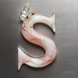 Rose quartz 'S' name DP in pink tones with gold veins and a glass butterfly for a luxurious look