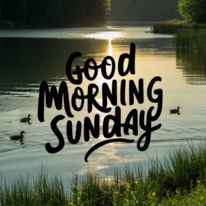 A calm lake reflecting the sunrise with 'Good Morning Sunday' in bold handwritten font."