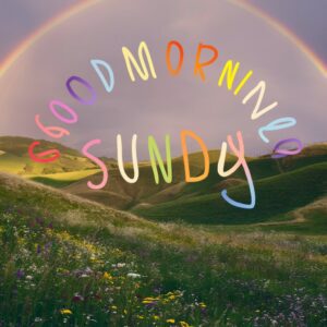 Rolling hills with a colorful arc of a rainbow creating a cheerful start to Sunday