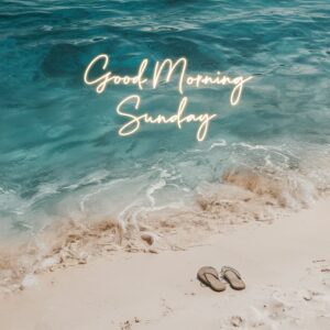 Calm waves on a sunny beach with neon-style 'Good Morning Sunday' text glowing above