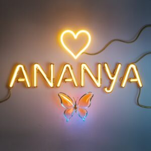 Golden Ananya logo glowing with neon orange-to-blue gradients, heart, and butterfly on silver background."